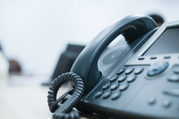 Illustrative desk telephone with a corded handset